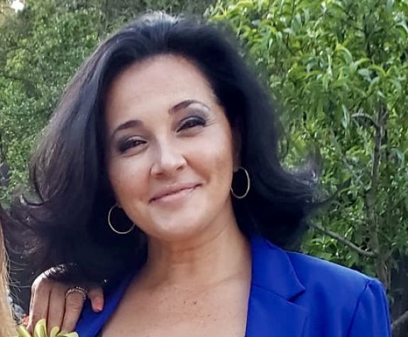 A woman smiles for a photo